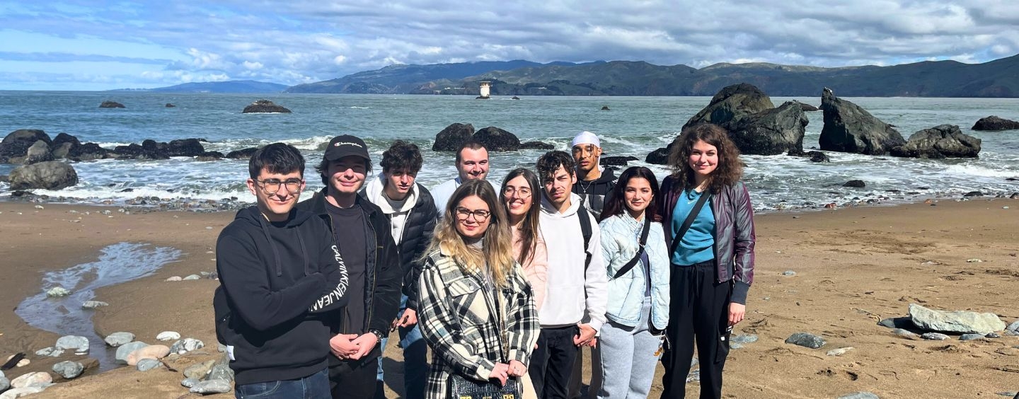 International students on a rocky beach