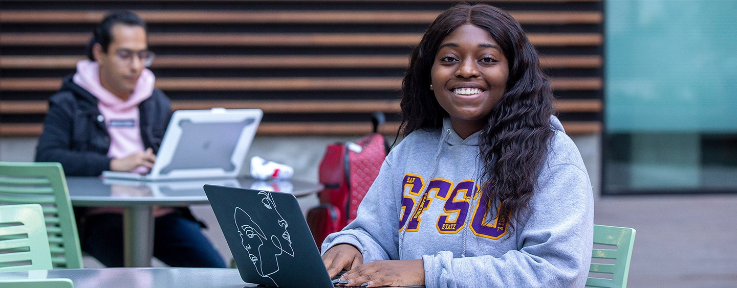 Student takes GE online courses outdoors