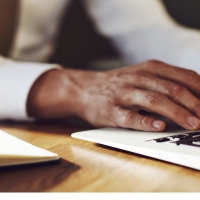 Professional man typing on laptop