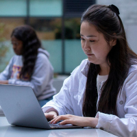 Student taking online course outdoors
