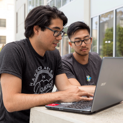 Pair of students studying on a laptop