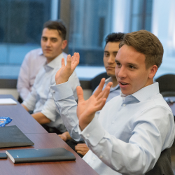 Business student talks with his hands in class