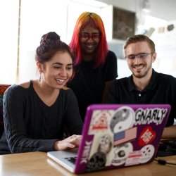 Project Management student trio working on a laptop