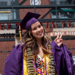 Graduate in regalia washed a peace sign