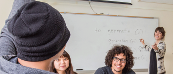 Student raises his hand and is called on by the teacher in English class