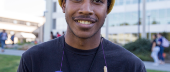 Winter Session student wearing a hat on campus