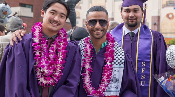 Three new graduates at Commencement