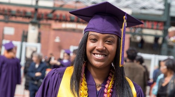 Smiling graduate in regalia