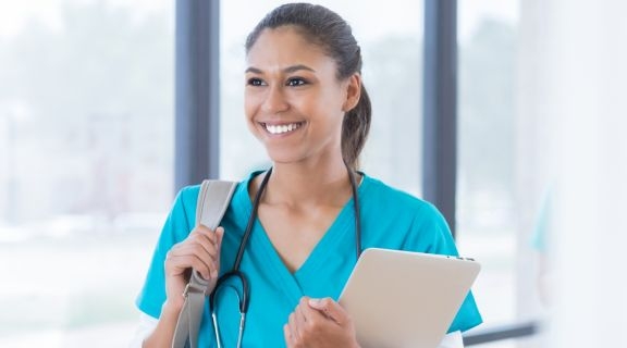 Medical student in scrubs with a backpack